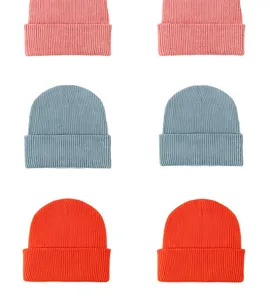 Close-up details of ribbed knit beanies in colorful dopamine shades for winter warmth.
