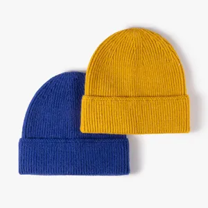 Winter warm knitted beanie hat, stylish cuffed couple wool cap in yellow and blue colors.