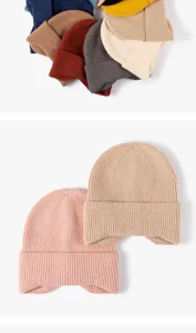 Detailed view of cozy knit beanies in multiple colors, featuring warm earflap design.