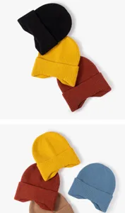 Close up detail of soft warm knit winter beanie hat showing fine ribbed texture and quality fabric.