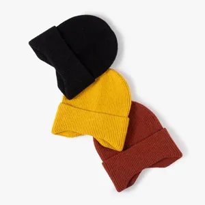 Core winter knitted beanie hats set in black yellow and brown colors displayed flat on white background.