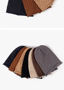 Detailed view of multiple knit slouchy beanies in various colors, soft and breathable fabric.