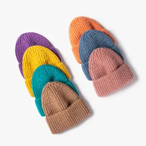 Stylish chunky knit beanie hats in vibrant multi-colors, warm and cozy winter accessories.