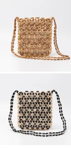Detailed view of handmade wooden beaded crossbody bag, intricate hollow weave pattern and strap.