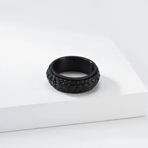Close-up of the black titanium steel dragon scale spinner ring, detailed retro punk band texture.