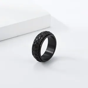 Close-up detail of black stainless steel dragon scale spinner ring, punk decompression jewelry.