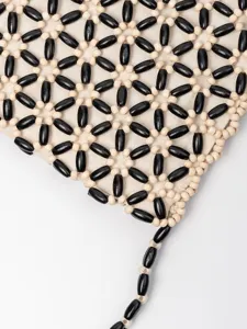 Handmade wooden beaded shoulder bag featuring a stylish black and beige geometric design.