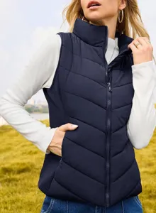 Close-up detail of women's navy blue quilted puffer vest with stand collar and front zipper.