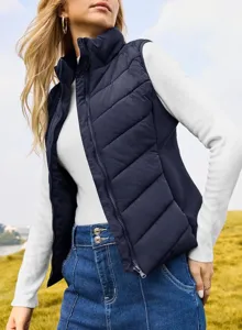 Detail view of a women's winter stand-up collar puffer vest, cozy sleeveless gilet.