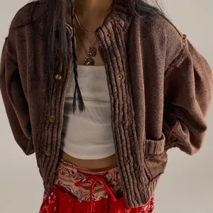 Vintage brown ribbed knit cardigan detail showing distressed texture, stand collar, and metal buttons.