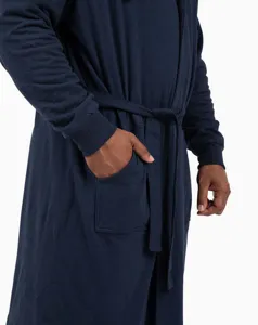 Close-up detail of soft hooded bathrobe pocket and waist belt in dark navy blue.
