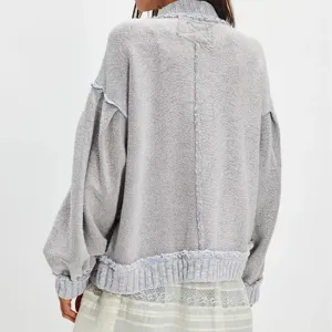 Back view detail of the grey distressed knit cardigan showing unique exposed seams and texture.