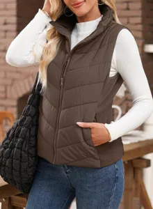 Close-up detail of casual stand-up collar sleeveless quilted puffer vest with zipper pockets.