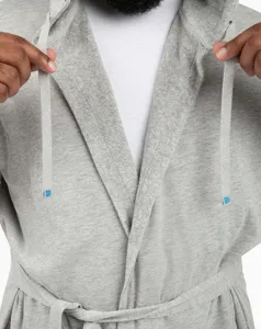 Detailed view of grey hooded bathrobe, soft fabric, adjustable drawstrings and tie belt.