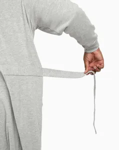 Close-up detail shot of the comfortable grey bathrobe belt and soft knitted fabric texture.