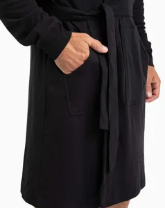 Black bathrobe detail shot, showing convenient front pockets and adjustable fabric belt.