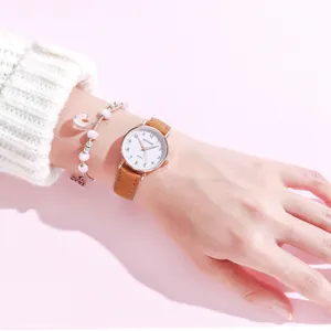 Minimalist women quartz watch with brown leather strap and white dial for elegant daily wear.