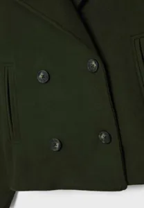 Dark green double-breasted wool blazer detail, chic lapel and button features for women.