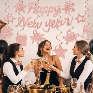 New Year party decoration set with glitter Happy New Year banner and hanging swirls for celebration.