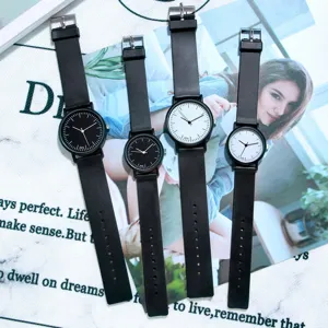 Minimalist quartz watch set with black and white dials and leather straps for men and women.