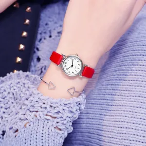 Minimalist red leather strap quartz watch detail shot, elegant small dial design for women.