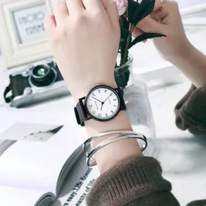 Minimalist quartz watch for women with black strap and white dial. Casual daily wrist wear.