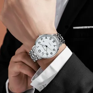 Detail shot of men's quartz watch with white dial, large numbers and silver steel bracelet.