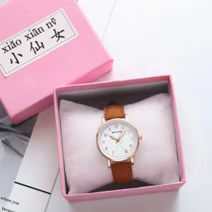 Detailed view of the cute pink quartz watch with brown leather strap and rose gold case.
