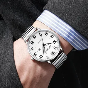 Detailed shot of a silver quartz watch with a white dial, large Arabic numerals, and metal band.