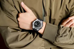 Close-up view of the rugged sport watch worn on wrist, featuring dual display and resin strap.