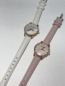 Detailed close-up shot of women quartz watches featuring textured dials and leather straps.