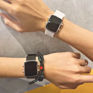 Detail shot of dual electronic wristwatches with square dial and silicone strap style.