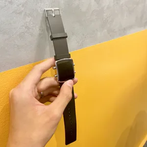 Detail view of the black silicone watch strap and metallic electronic display case design.