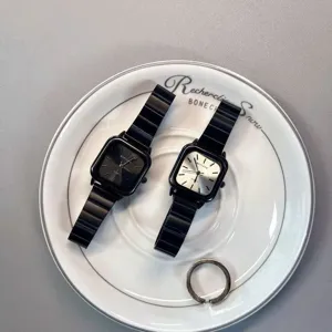 Detail shot of niche design women's square watches with black stainless steel straps and dials.