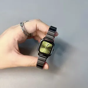 Minimalist square quartz watch for women featuring green dial and stylish black steel band.