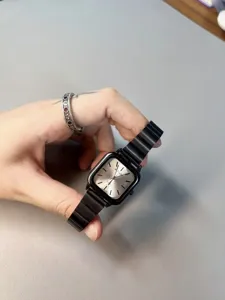Black square quartz watch for women with stylish metal strap and elegant silver dial detail.