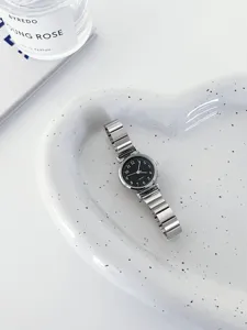 Elegant women quartz watch with black dial and silver metallic strap for daily wear style.