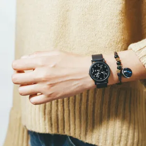 Stylish minimalist quartz watch with constellation dial and comfortable sleek black strap.
