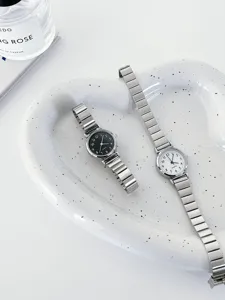 Minimalist metal strap quartz watch set, elegant black and white dial wristwatches detail.