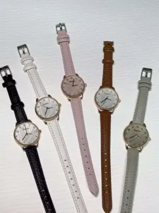 Detail view of stylish minimalist women quartz watches with colorful leather straps and dials.