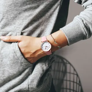 Pink leather strap women watch detail shot showing clean white dial and minimalist cute numbers.