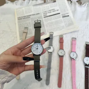 Casual student quartz watch with canvas strap, minimalist design, lightweight daily wear.