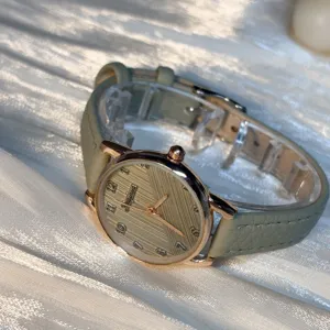 Minimalist green leather strap quartz watch for women, stylish student wristwatch, chic design.