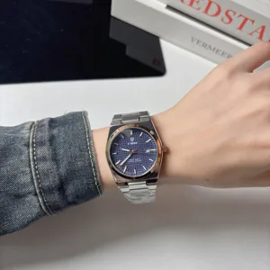 Luxury quartz wristwatch with metal strap, stylish blue dial and calendar display for daily wear.