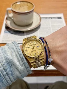 Men's gold quartz watch with honeycomb dial, calendar display, and stylish metal bracelet for daily wear.