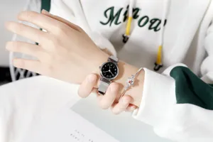 Minimalist women's quartz watch with mesh strap and floral bracelet set for daily wear.