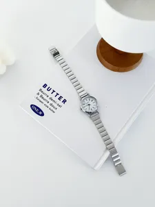 Minimalist stainless steel strap women watch detail view, vintage small dial aesthetic design.