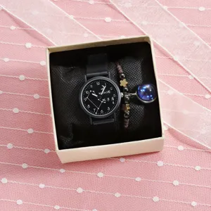 Close-up detail of a quartz watch with constellation dial and matching bracelet in box.