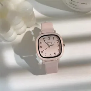 Detailed shot of a minimalist pink square dial women watch with matching leather strap elegant style.