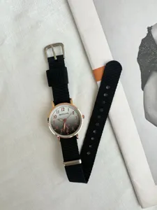 Detail view of a stylish casual quartz watch featuring a black canvas strap and gradient dial.